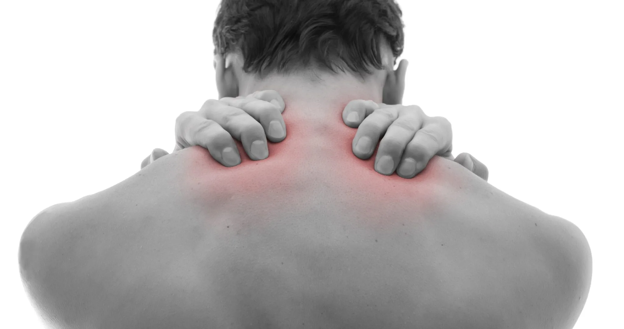 Person holding their neck and shoulder in discomfort from muscle tension
